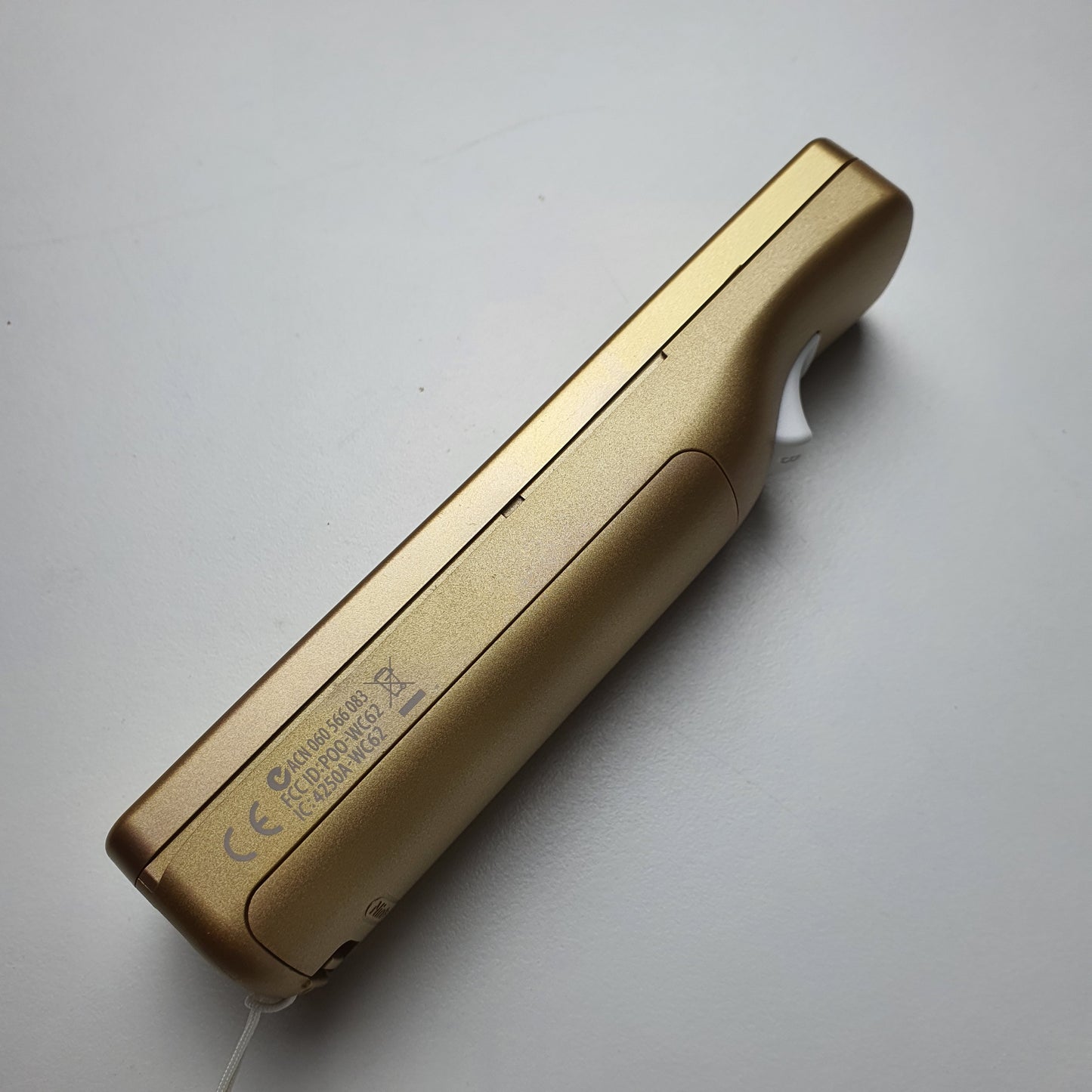 One side of a gold-coloured Nintendo Wii/Wii U limited edition 'Zelda: Skyward Sword' remote.