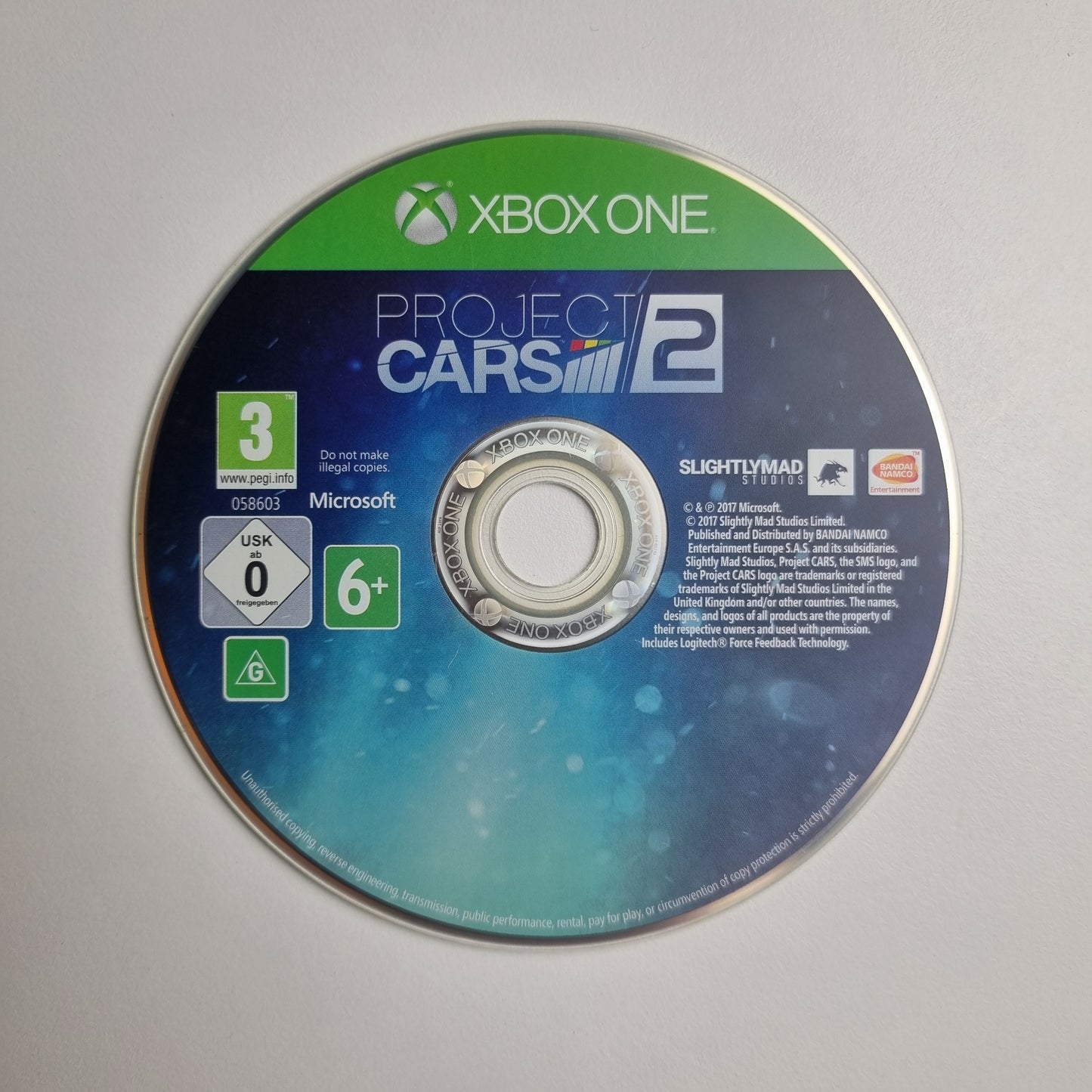Xbox One game disc for 'Project Cars 2' on a grey background