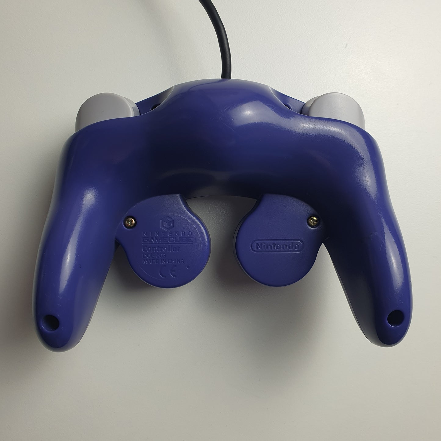 Back of an official indigo Nintendo GameCube controller on a white background.