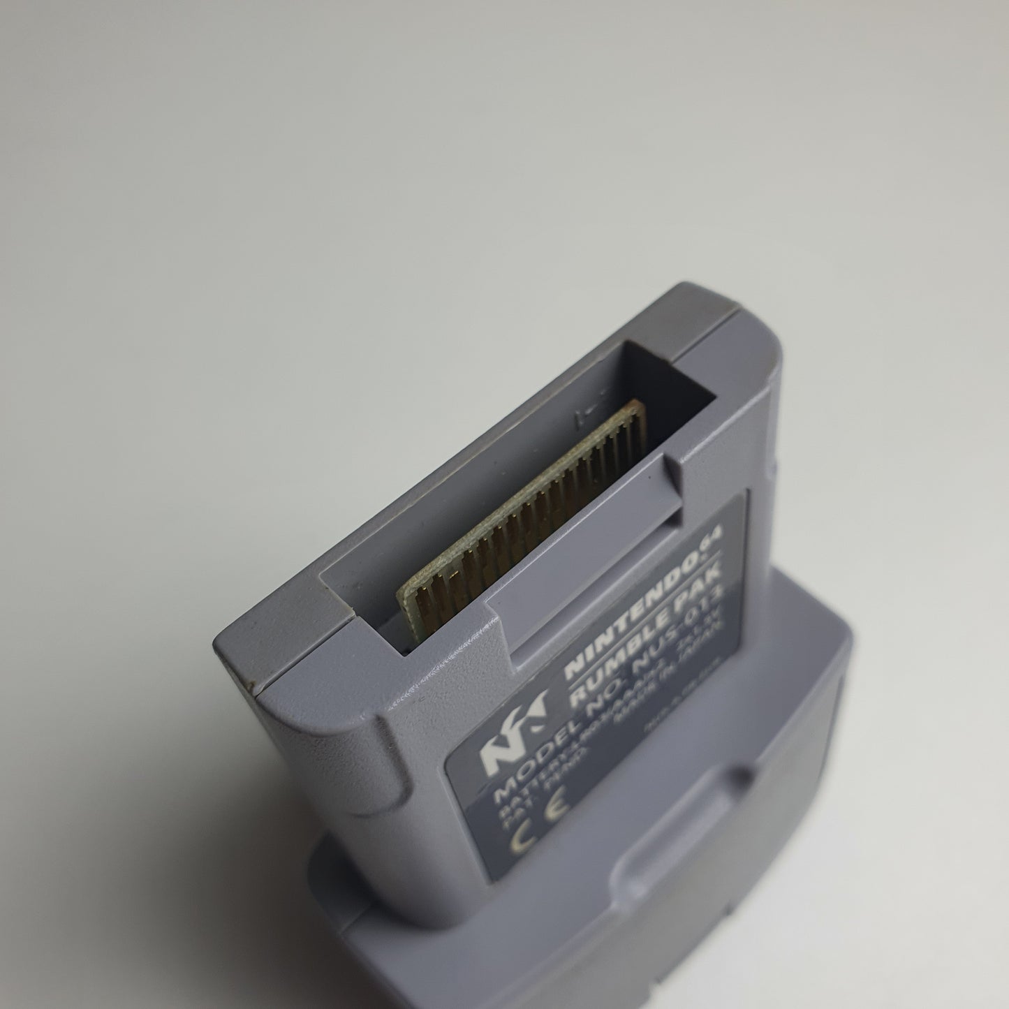 Close-up of the socket of a Nintendo 64 N64 rumble pak on a white background