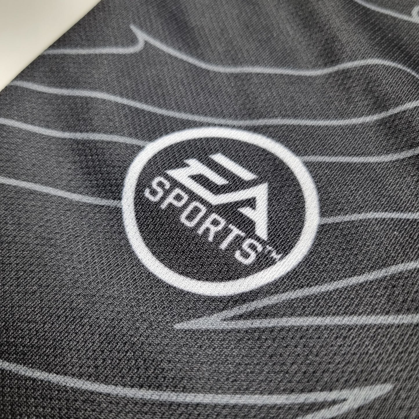 Close-up of a the EA Sports logo on a textured fabric surface