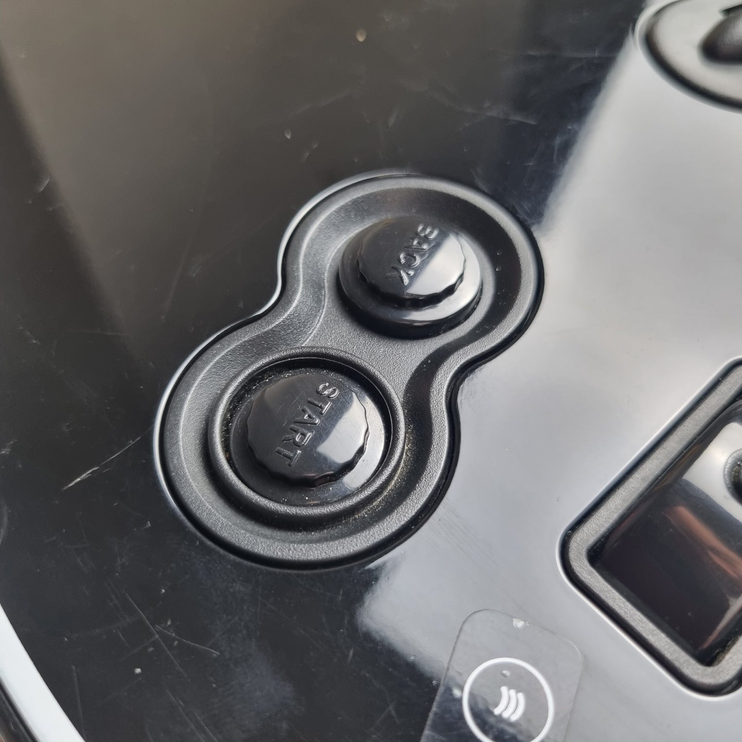 Close-up of buttons of a official RedOctane Xbox 360 Gibson Les Paul black guitar controller on a white background.