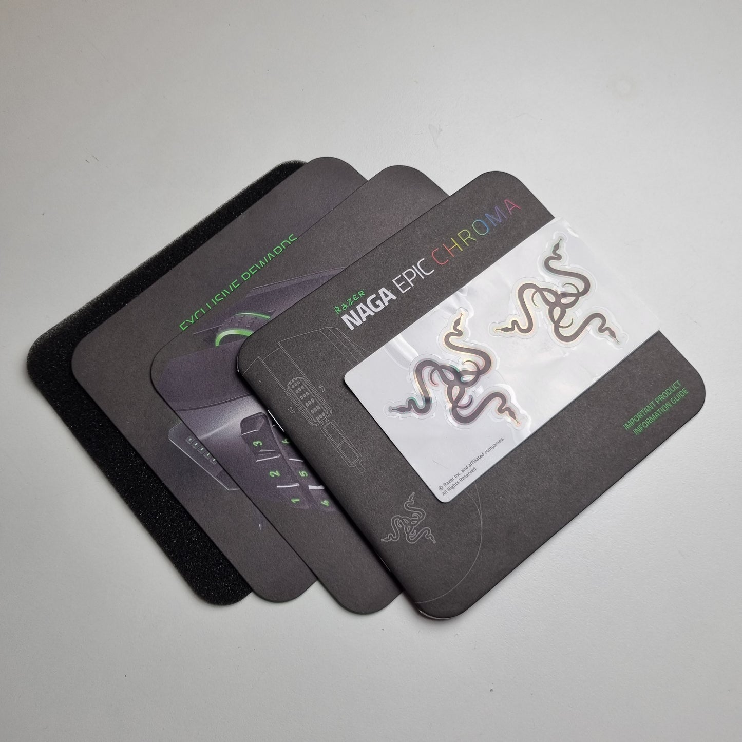 Manuals and inserts for a Razer Naga Epic Chroma gaming mouse on a light grey background