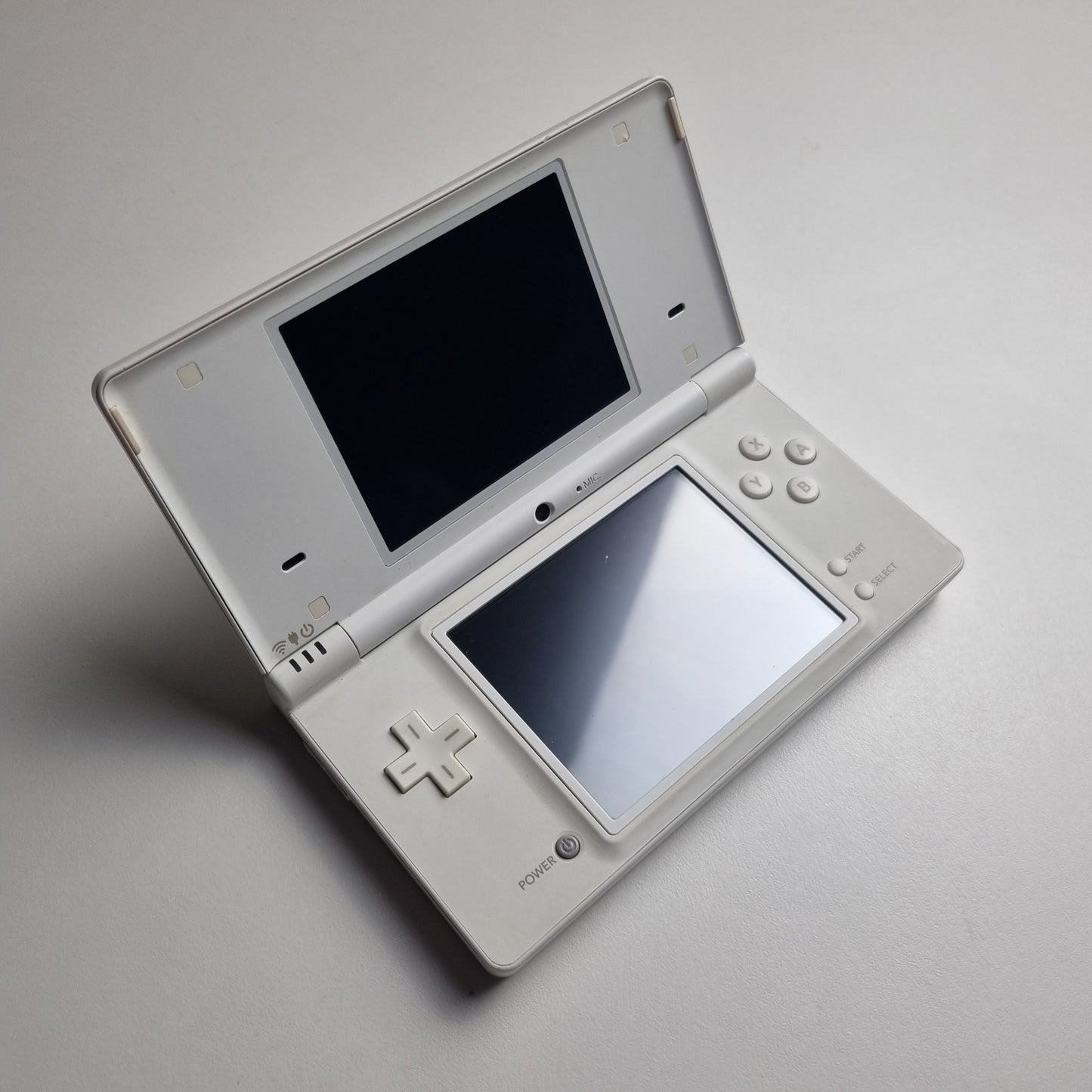 White Nintendo DSi handheld console on a light grey background.