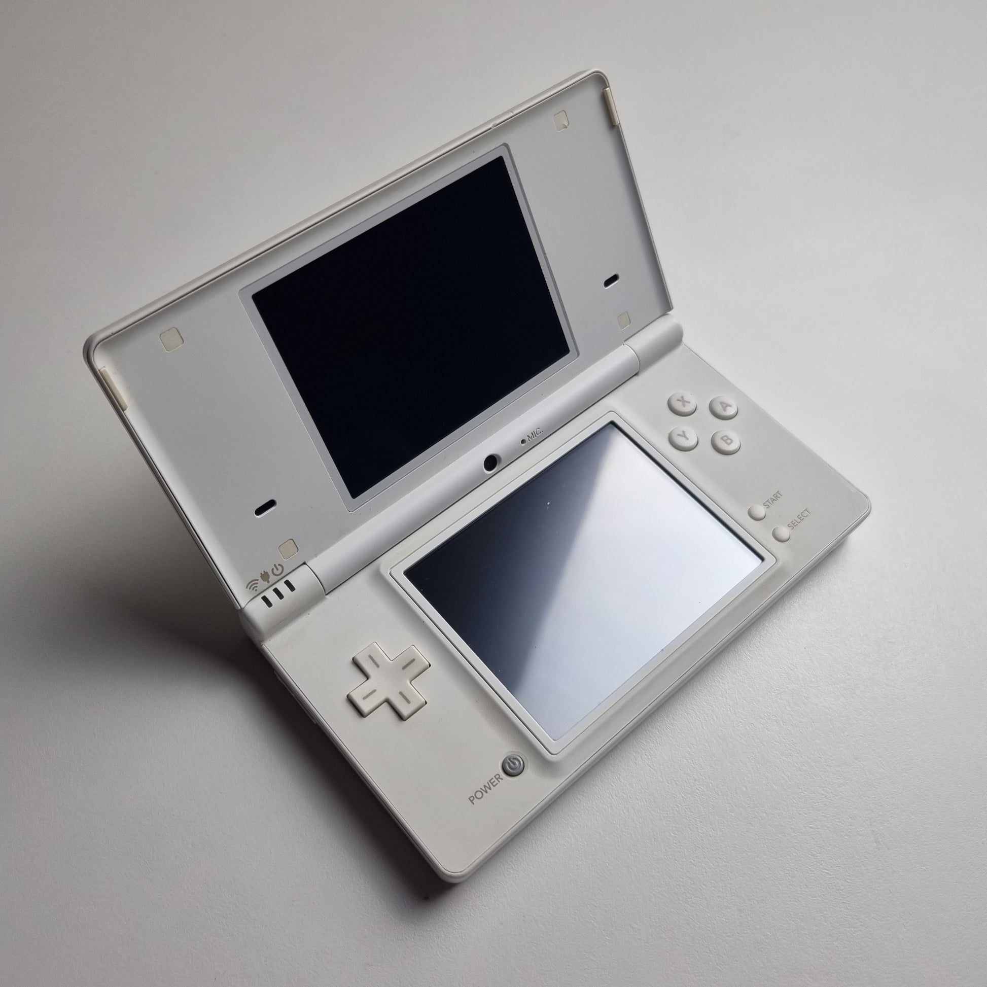 White Nintendo DSi handheld console on a light grey background.