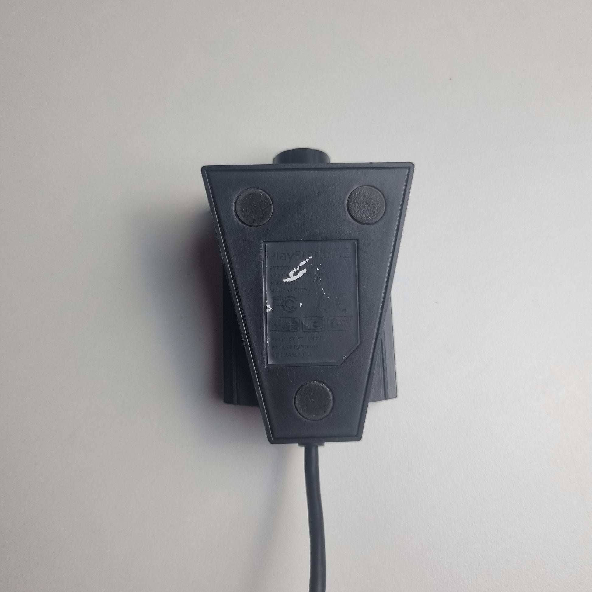 Bottom of a refurbished PlayStation 2 EyeToy camera on a white background.