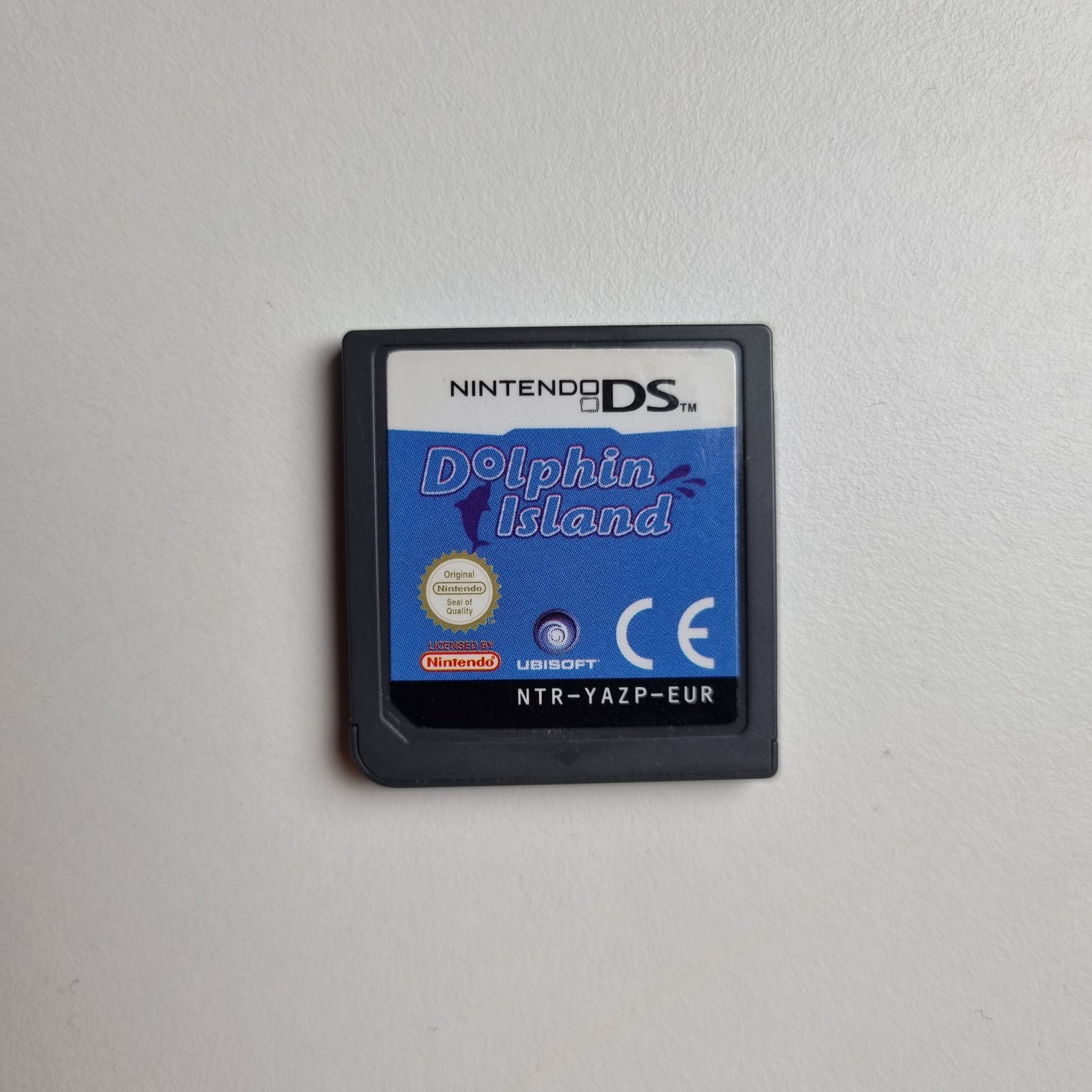Nintendo DS game cartridge for 'Dolphin Island' on a white background