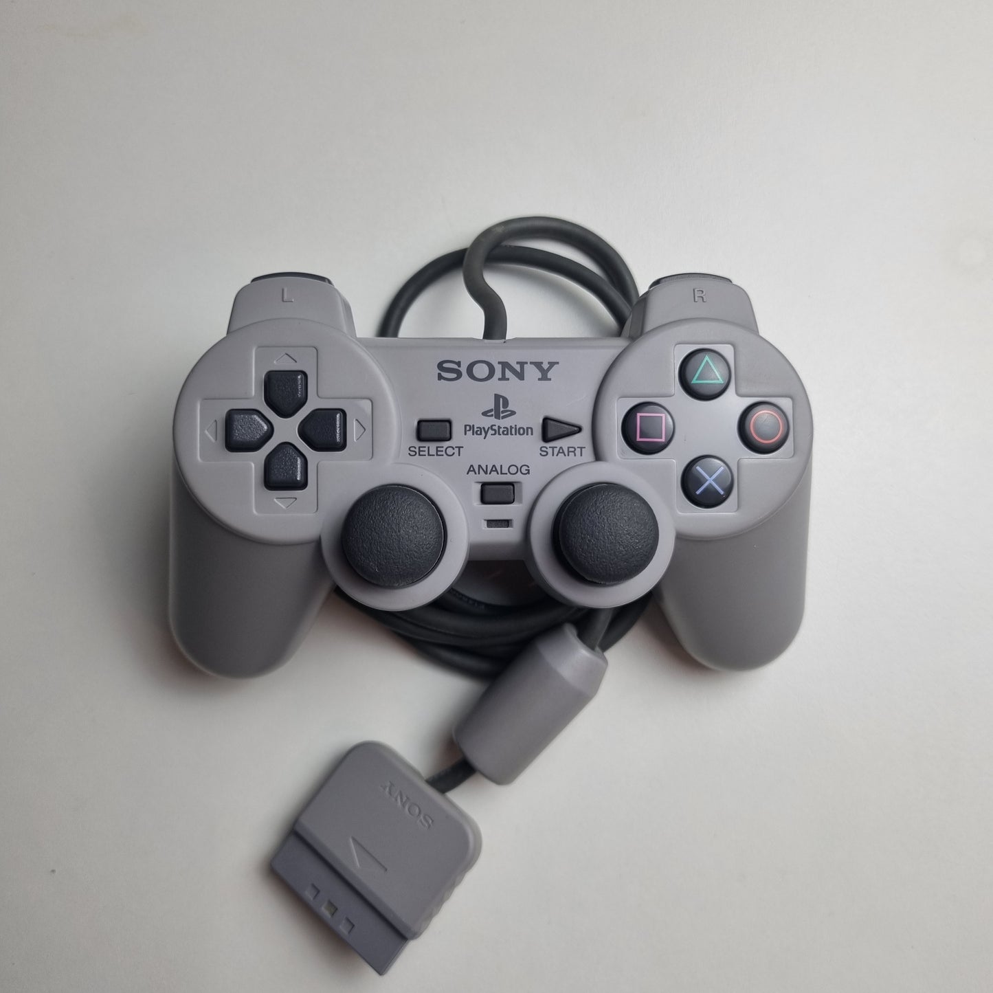 Refurbished official Sony PlayStation DualShock wired grey controller, on a white background.