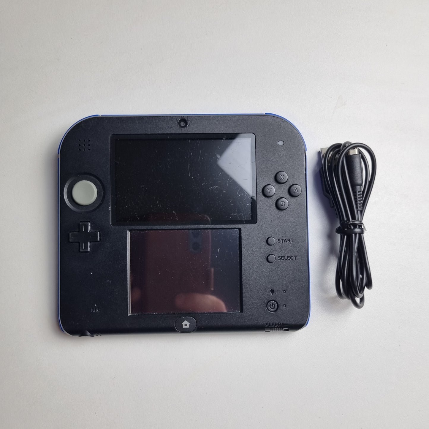 Refurbished Nintendo 2DS black handheld gaming console with two screens and a cable on a light grey background