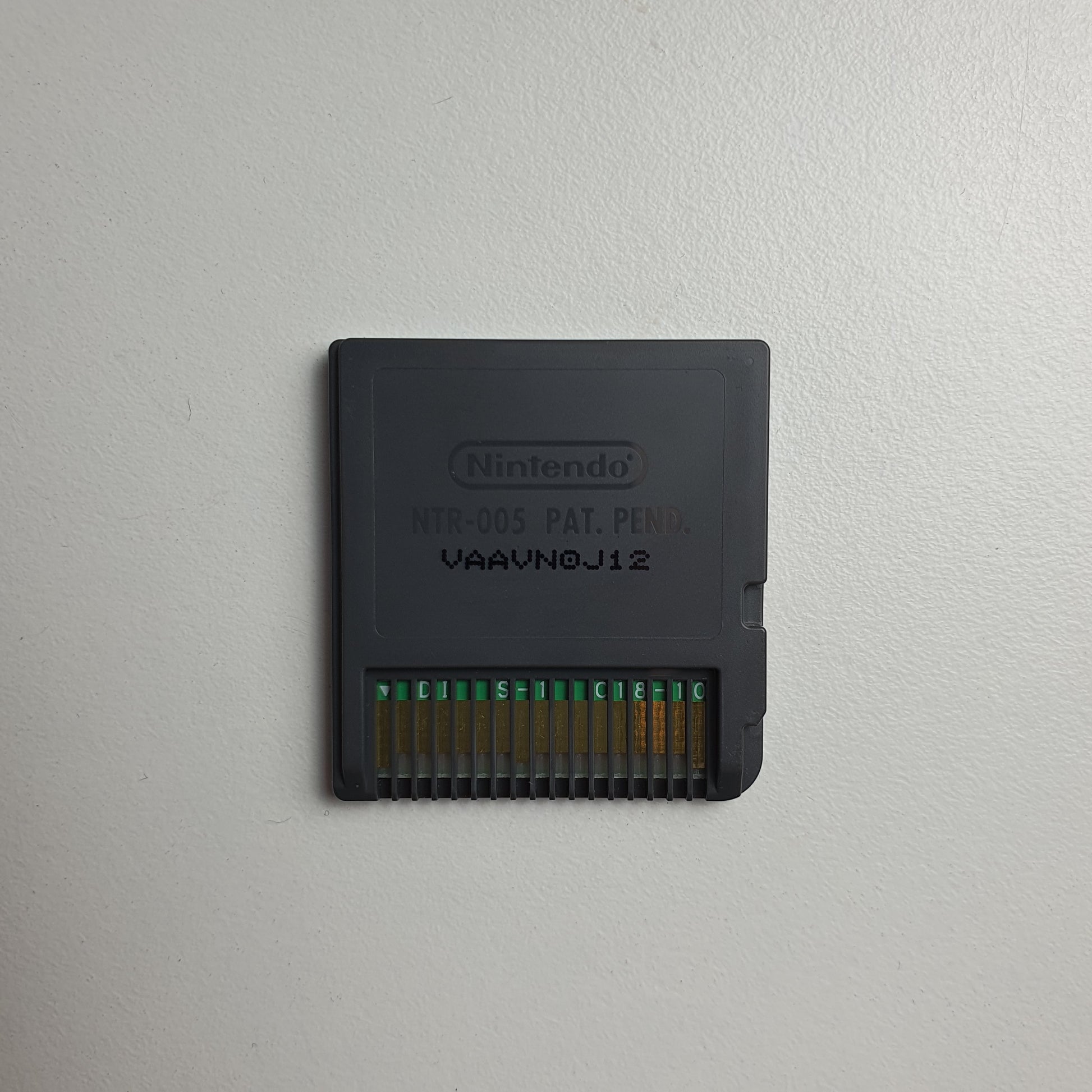 Back of a Nintendo DS game cartridge on a light grey background