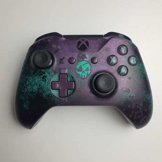 Front of a turquoise & purple Xbox One 'Sea of Thieves' controller on a white background