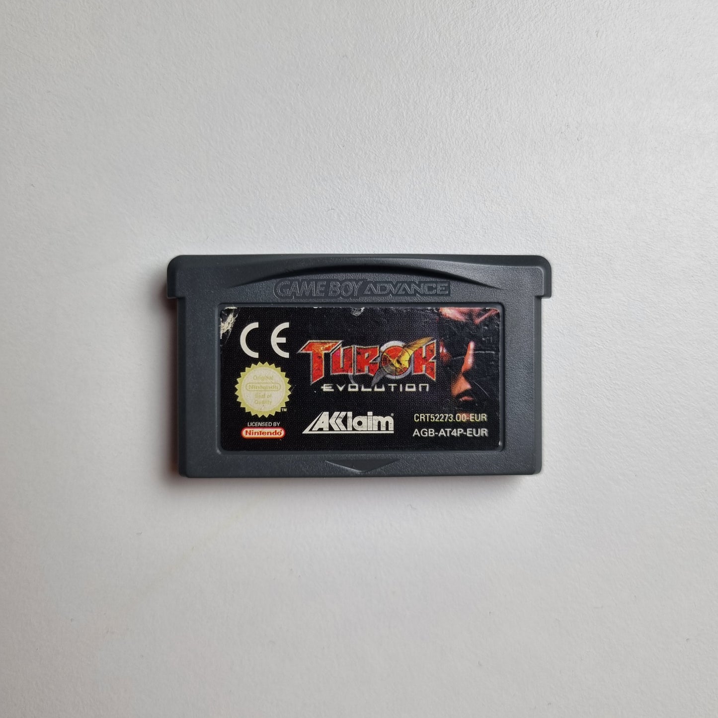 Game Boy Advance game cartridge for 'Turok: Evolution' on a light grey background