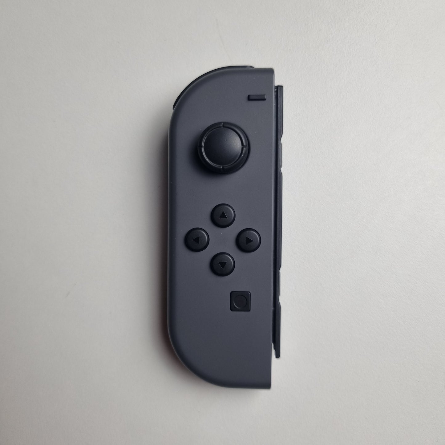 Grey Nintendo Switch Joy-Con on a white background.