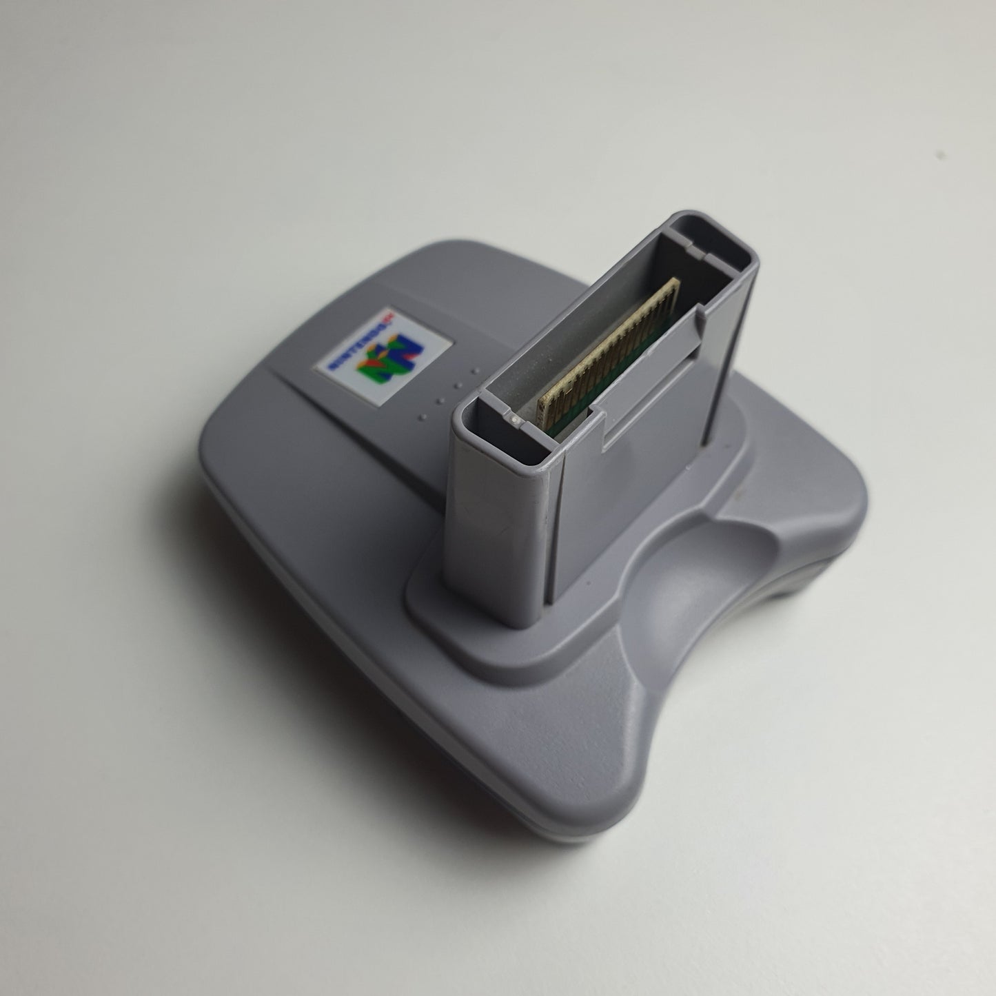 Nintendo 64 N64 transfer pak on a white background