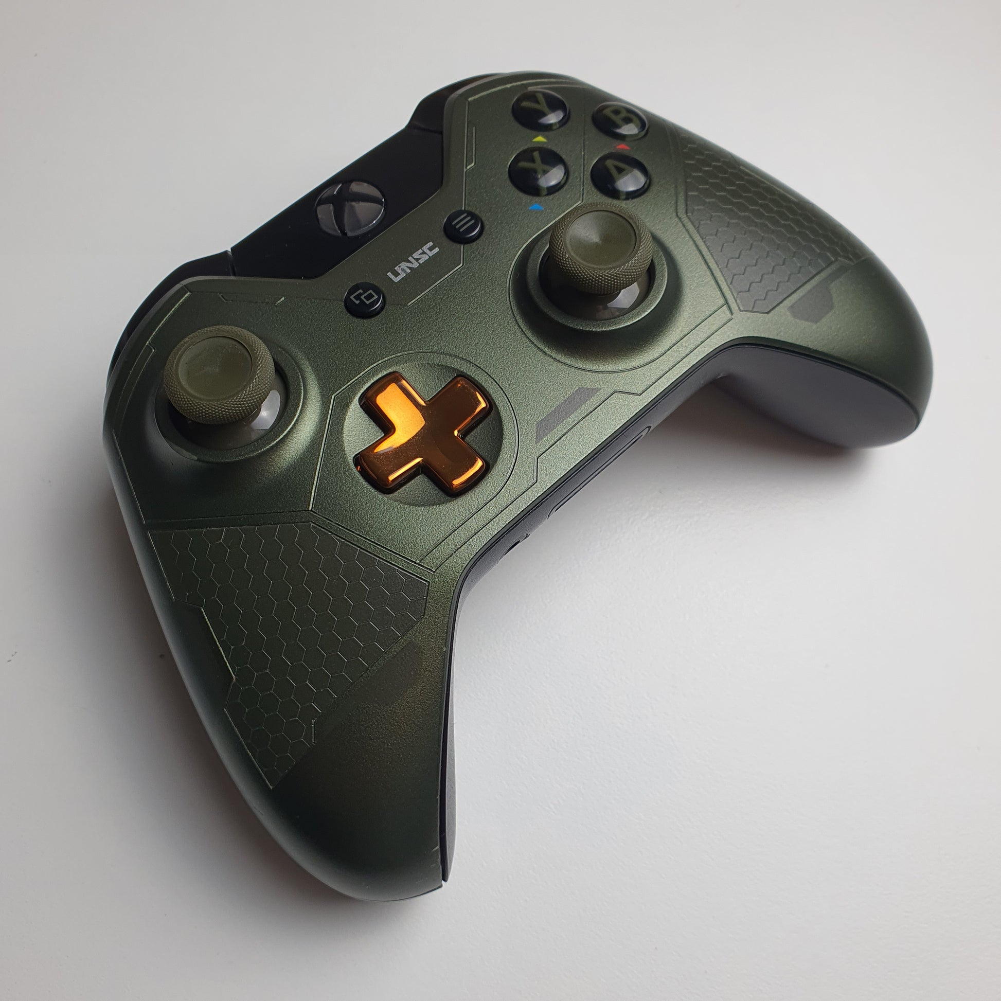 Front of a green & copper coloured Xbox One 'Master Chief' controller on a white background
