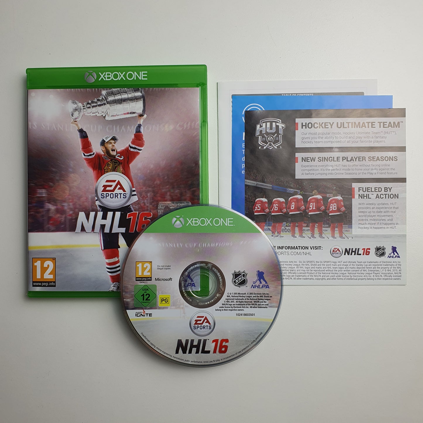 NHL 16 game case, disc and manual on a white background