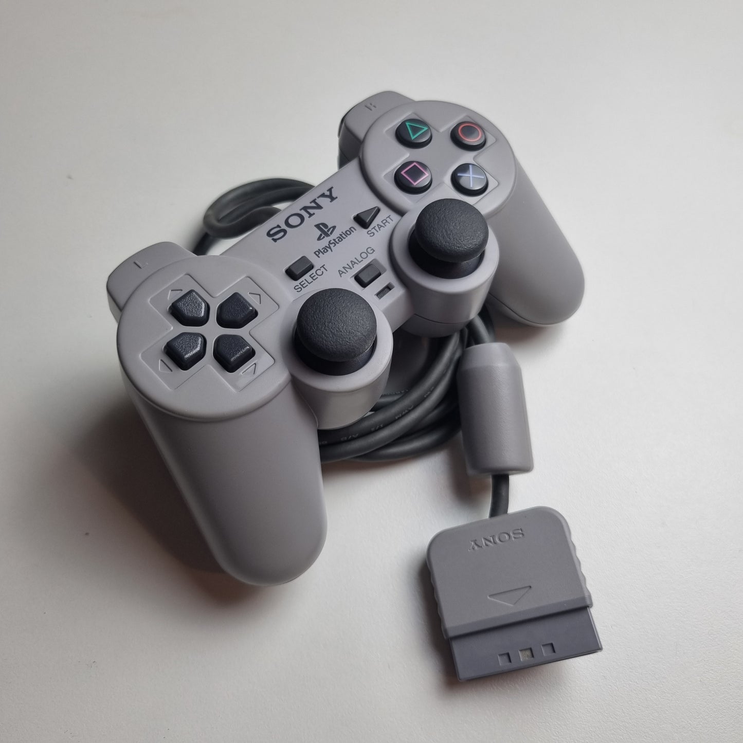Refurbished official Sony PlayStation DualShock wired grey controller, on a white background.