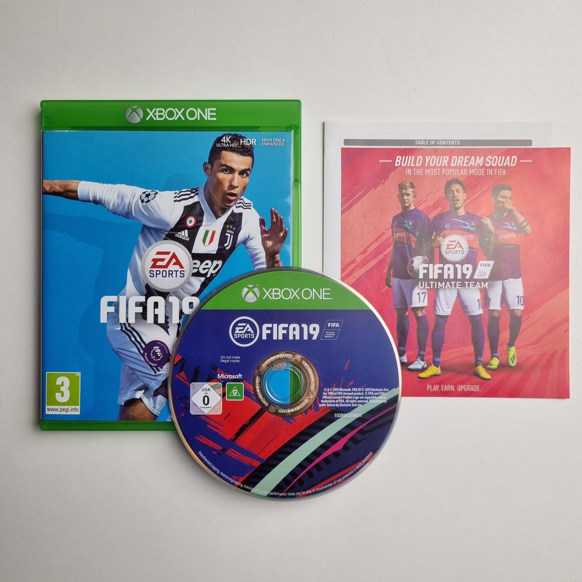 Xbox One game case, disc and inserts for 'FIFA 19' on a light grey background