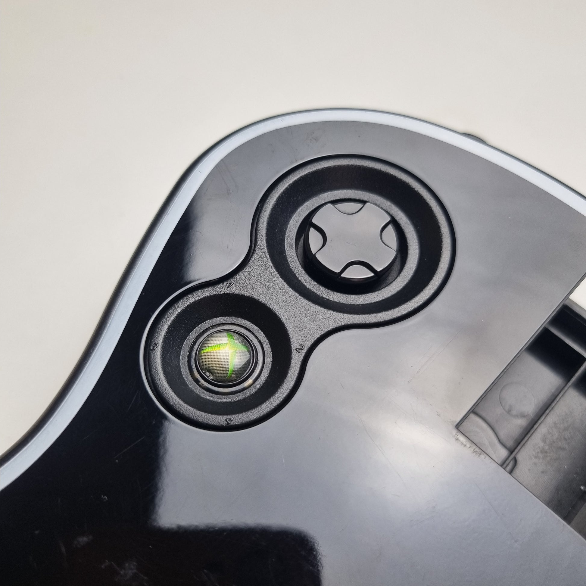 Close-up of buttons of a official RedOctane Xbox 360 Gibson Les Paul black guitar controller on a white background.