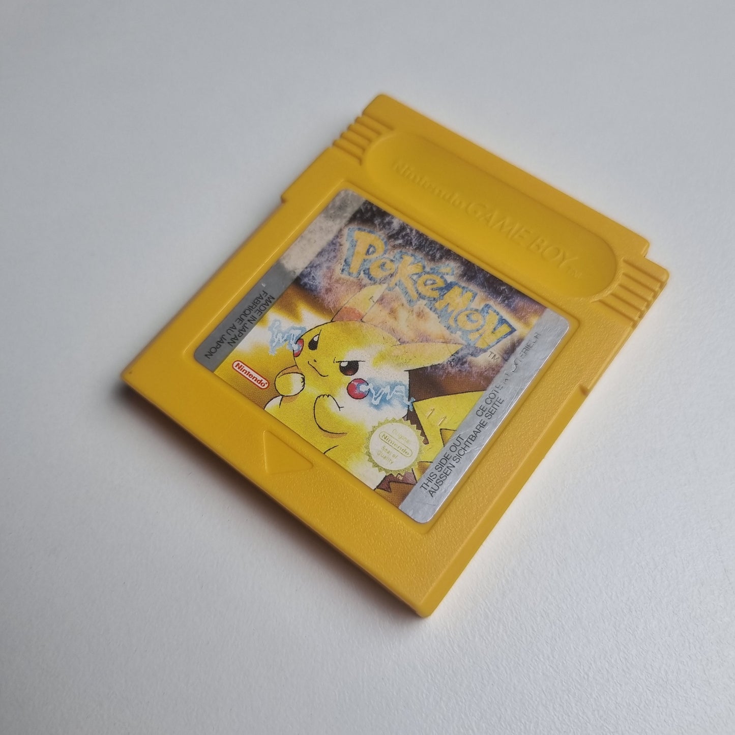 'Pokémon: Yellow Version' video game cartridge for Game Boy showing the character Pikachu. The label has wear from use.