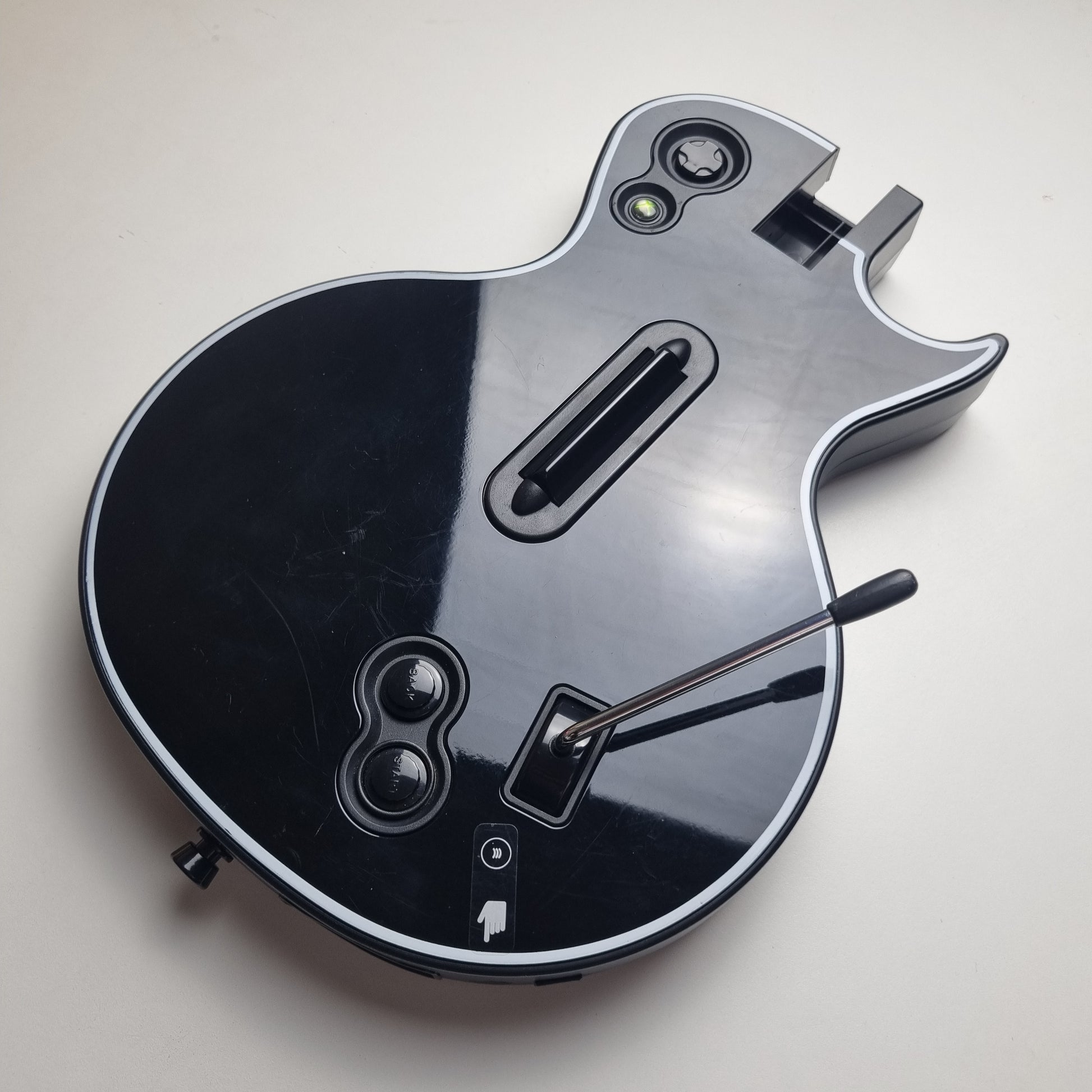 Body of a official RedOctane Xbox 360 Gibson Les Paul black guitar controller on a white background.