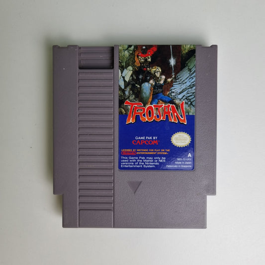 Nintendo Entertainment System game cartridge with 'Trojan' cover featuring a character holding a sword.