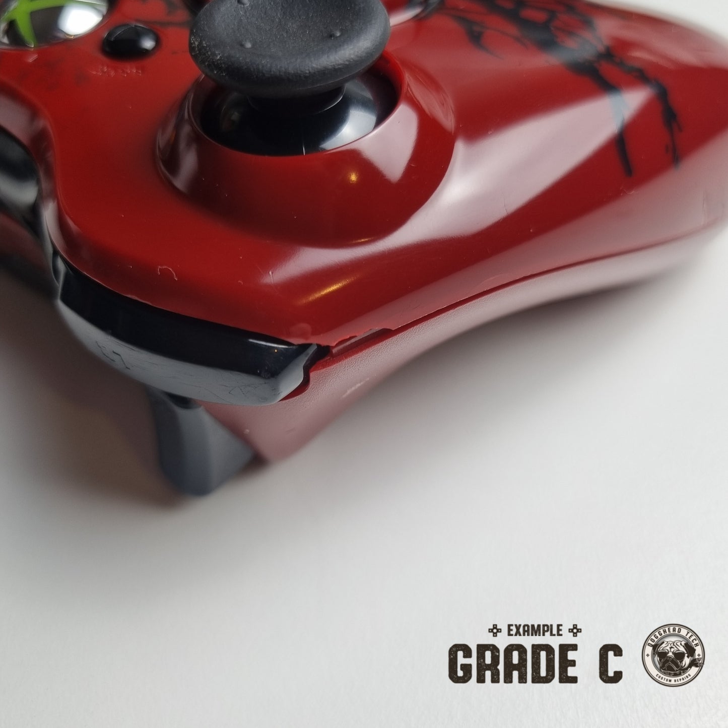 Official Xbox 360 'Gears of War 3' controller showing broken plastic near the trigger button with text in the bottom right corner of the image that reads "Example Grade C".