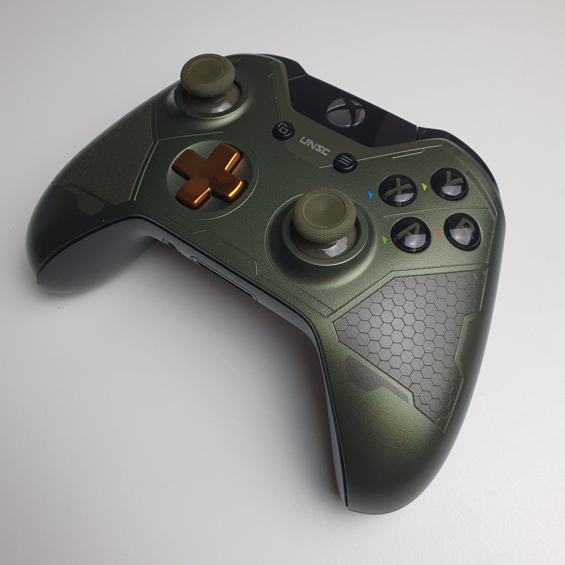Front of a green & copper coloured Xbox One 'Master Chief' controller on a white background