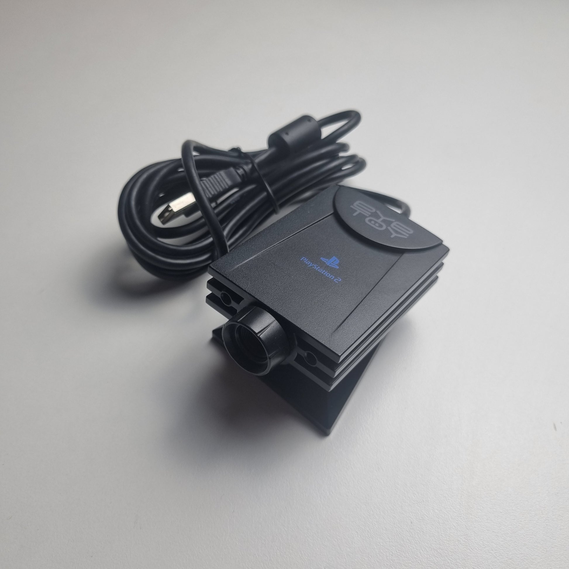 Refurbished PlayStation 2 EyeToy Camera, showing USB cable on a white background.