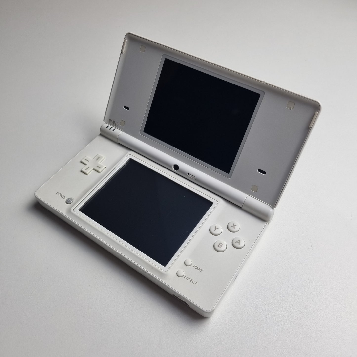 White Nintendo DSi handheld console on a light grey background.