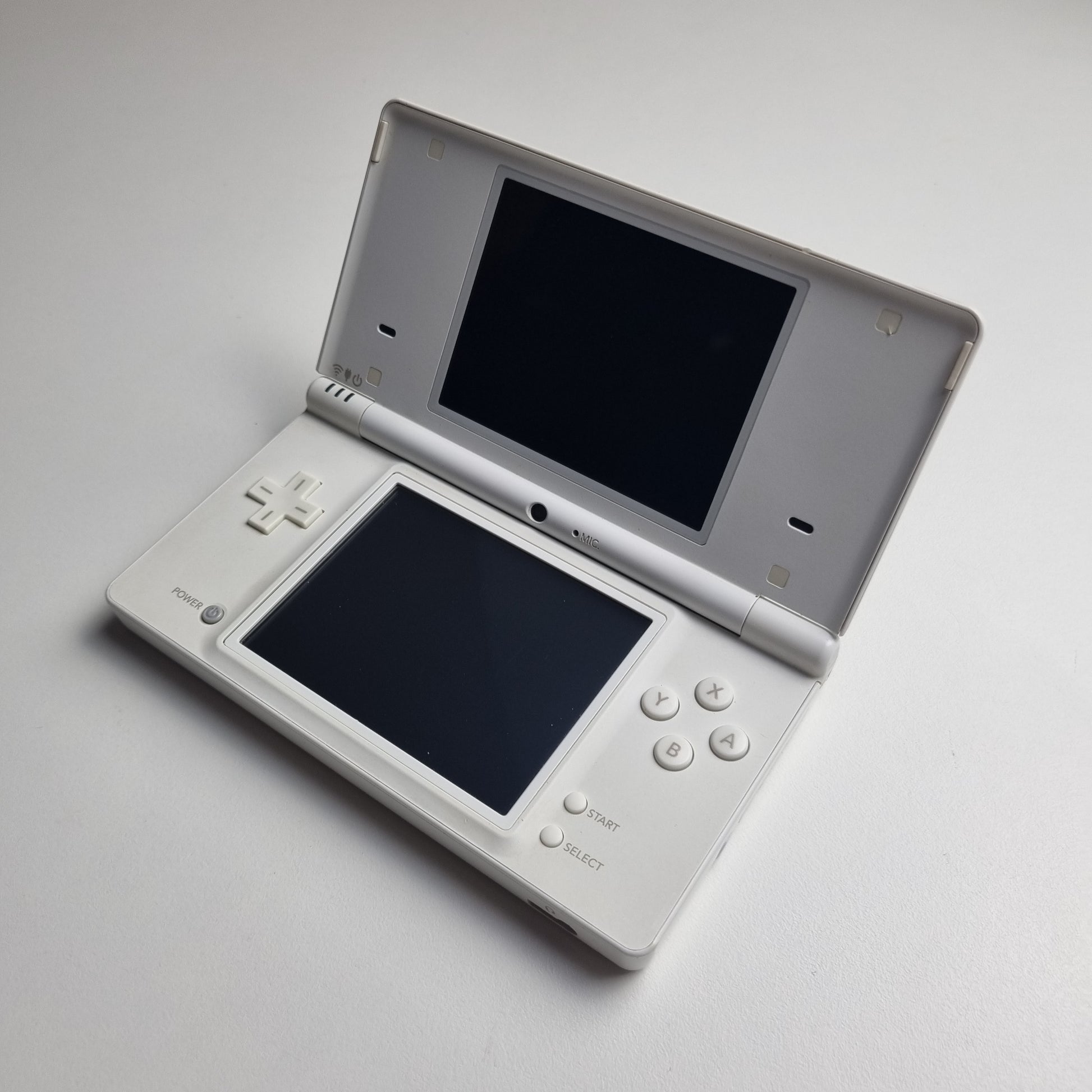 White Nintendo DSi handheld console on a light grey background.