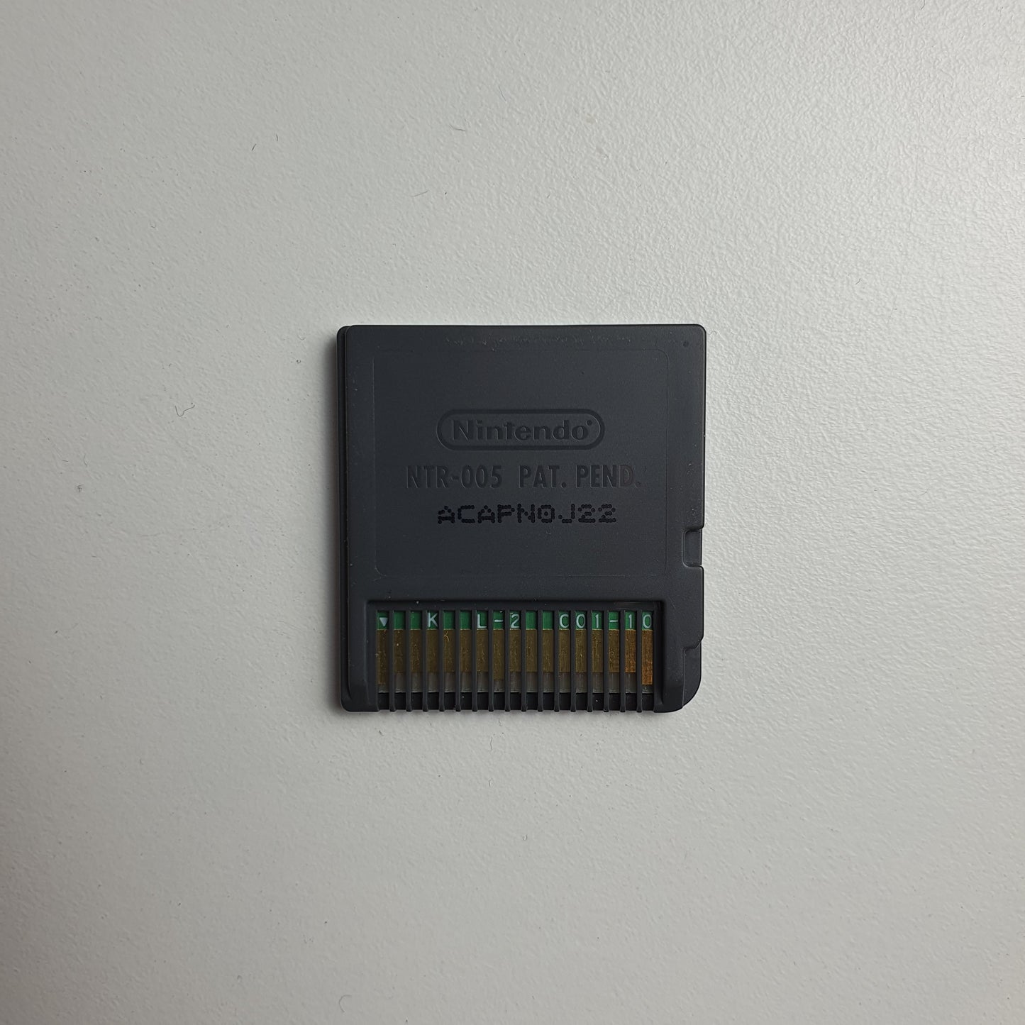 Back of a Nintendo DS game cartridge on a light grey background