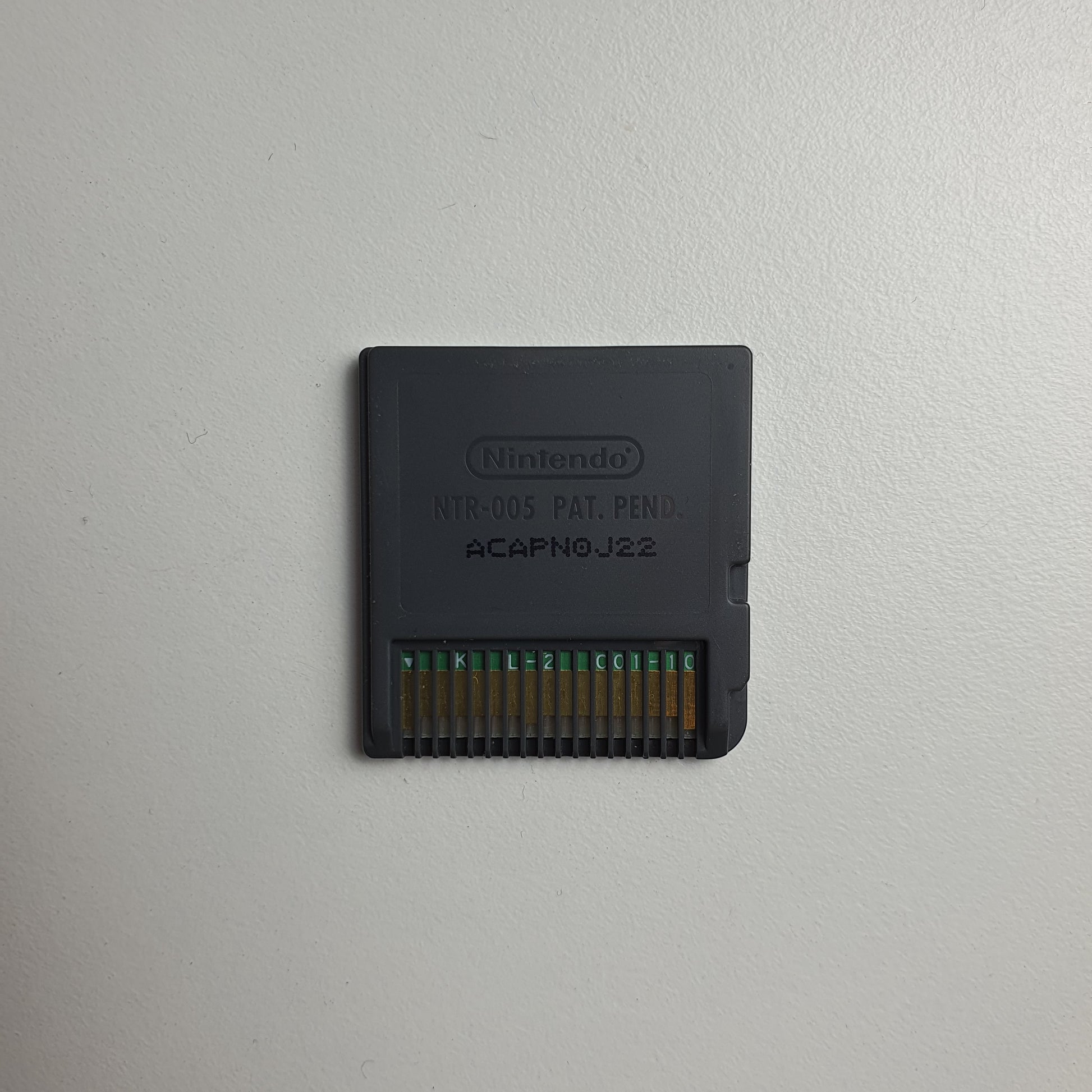 Back of a Nintendo DS game cartridge on a light grey background