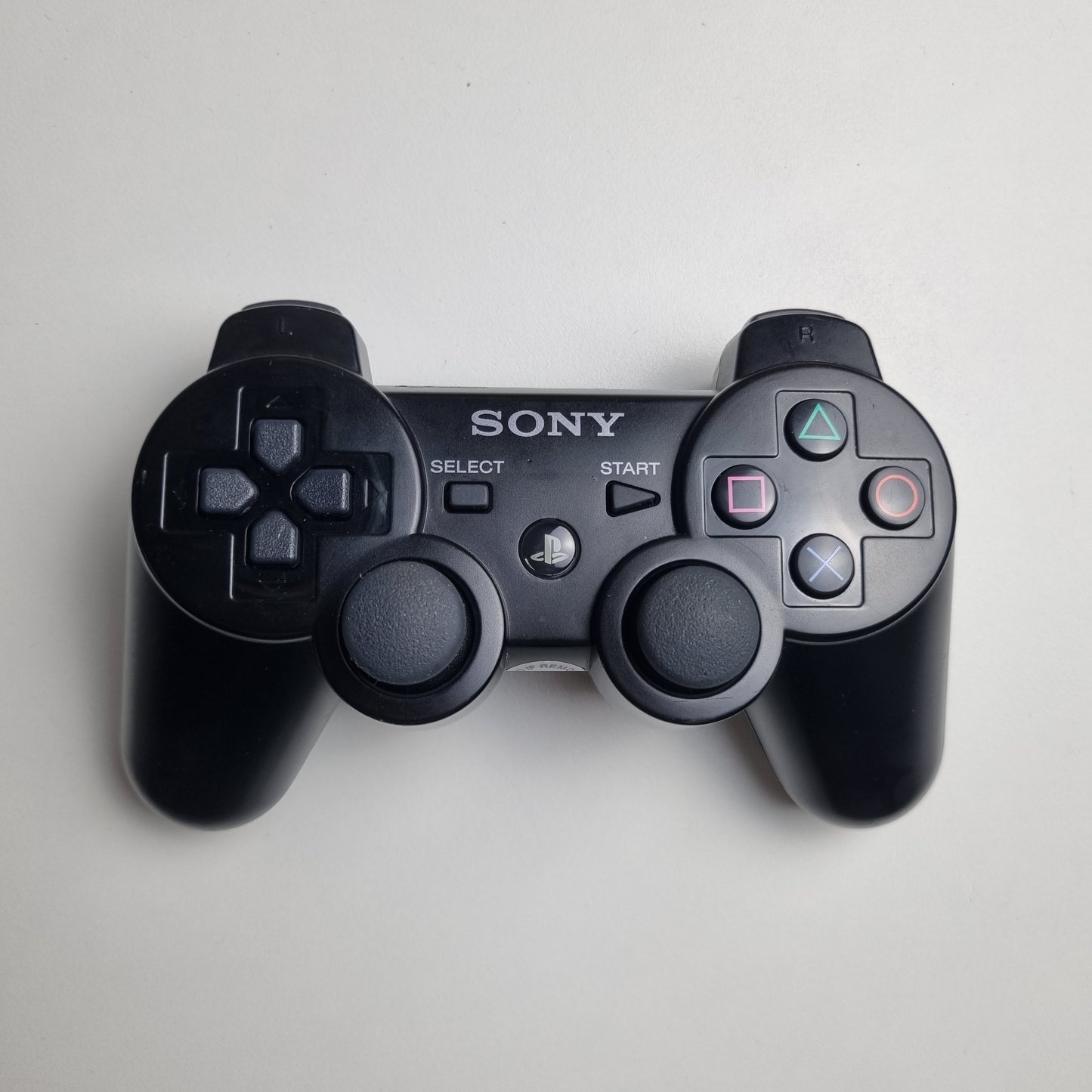 Official Sony PlayStation PS3 SIXAXIS black wireless controller on a white background.