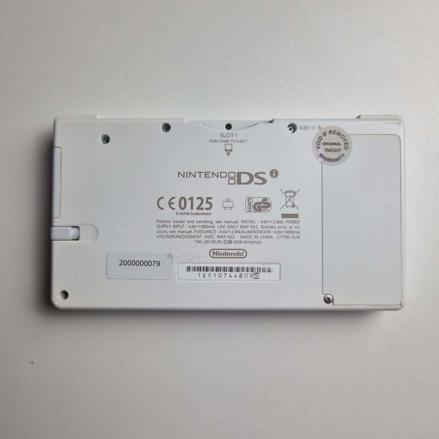 Back view of a Nintendo DSi device on a grey background