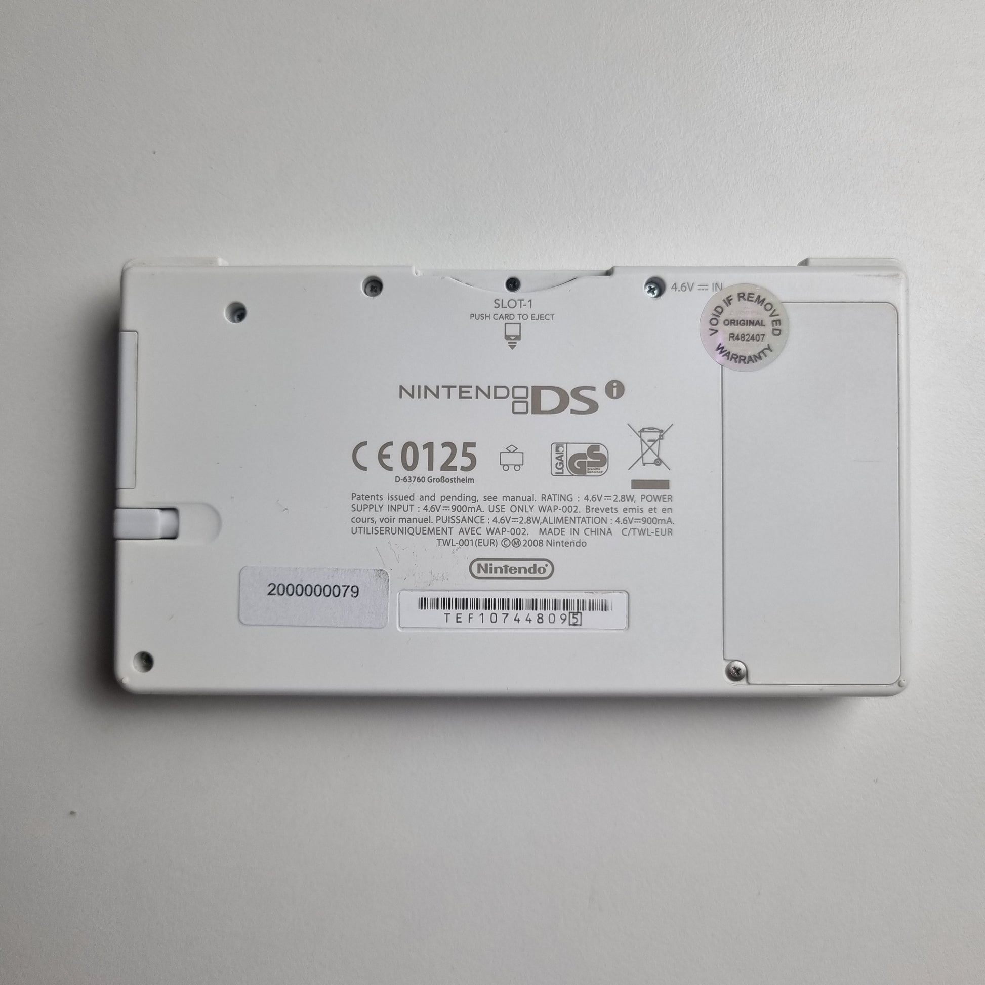 Back view of a Nintendo DSi device on a grey background