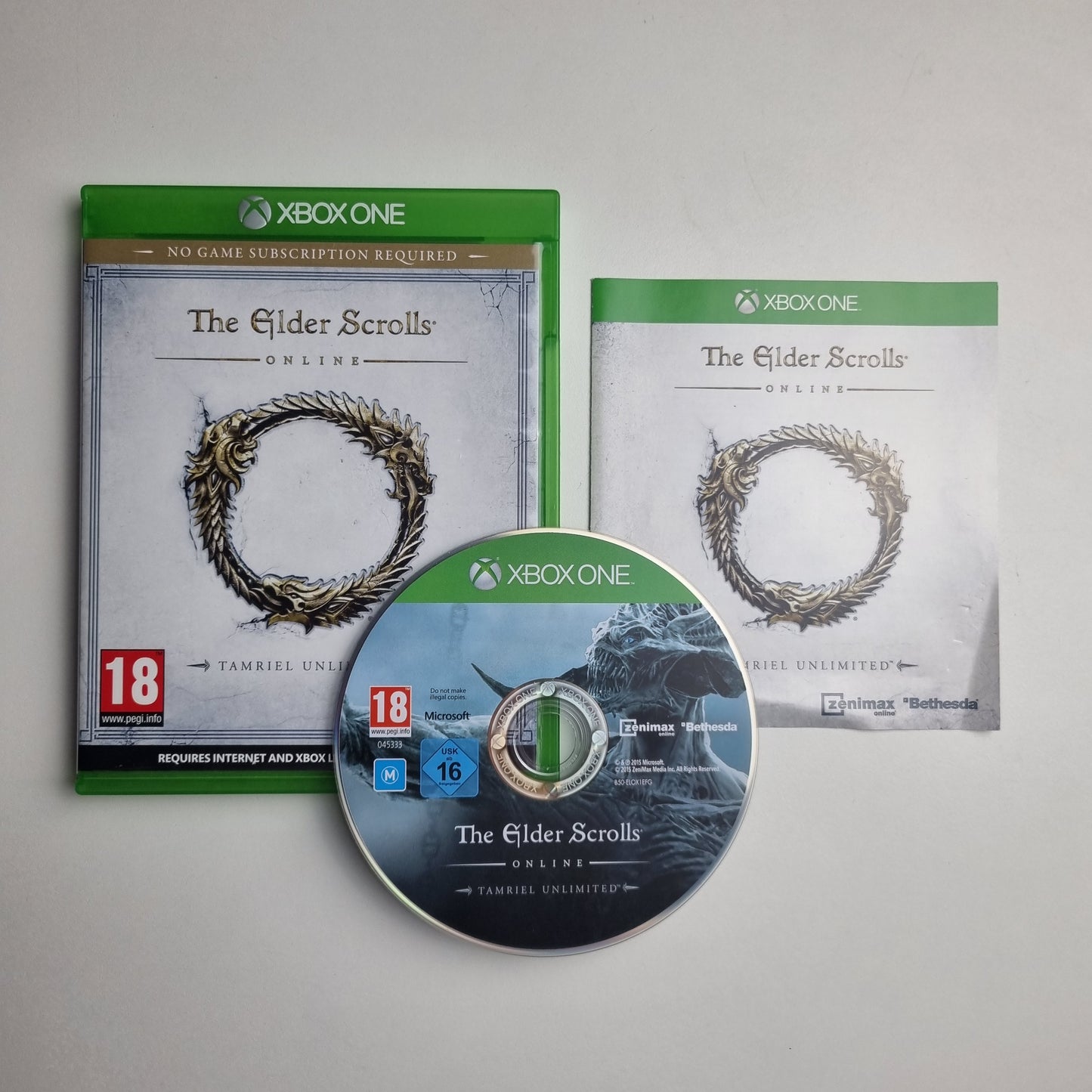 Xbox One game disc, case and insert for 'The Elder Scrolls Online: Tamriel Unlimited' on a grey background