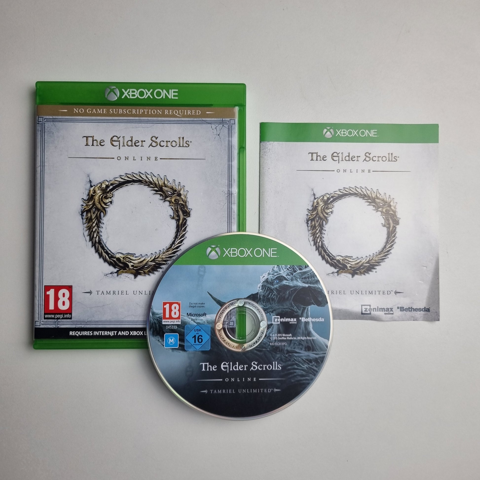 Xbox One game disc, case and insert for 'The Elder Scrolls Online: Tamriel Unlimited' on a grey background