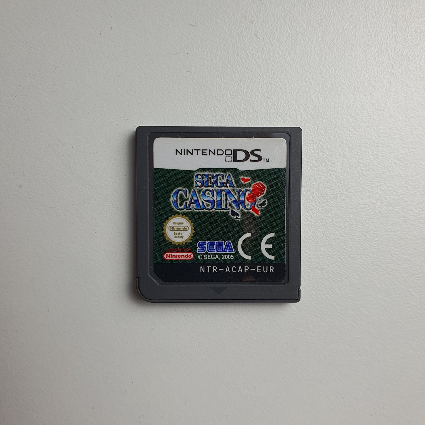 Nintendo DS game cartridge for Sega Casino on a light grey background
