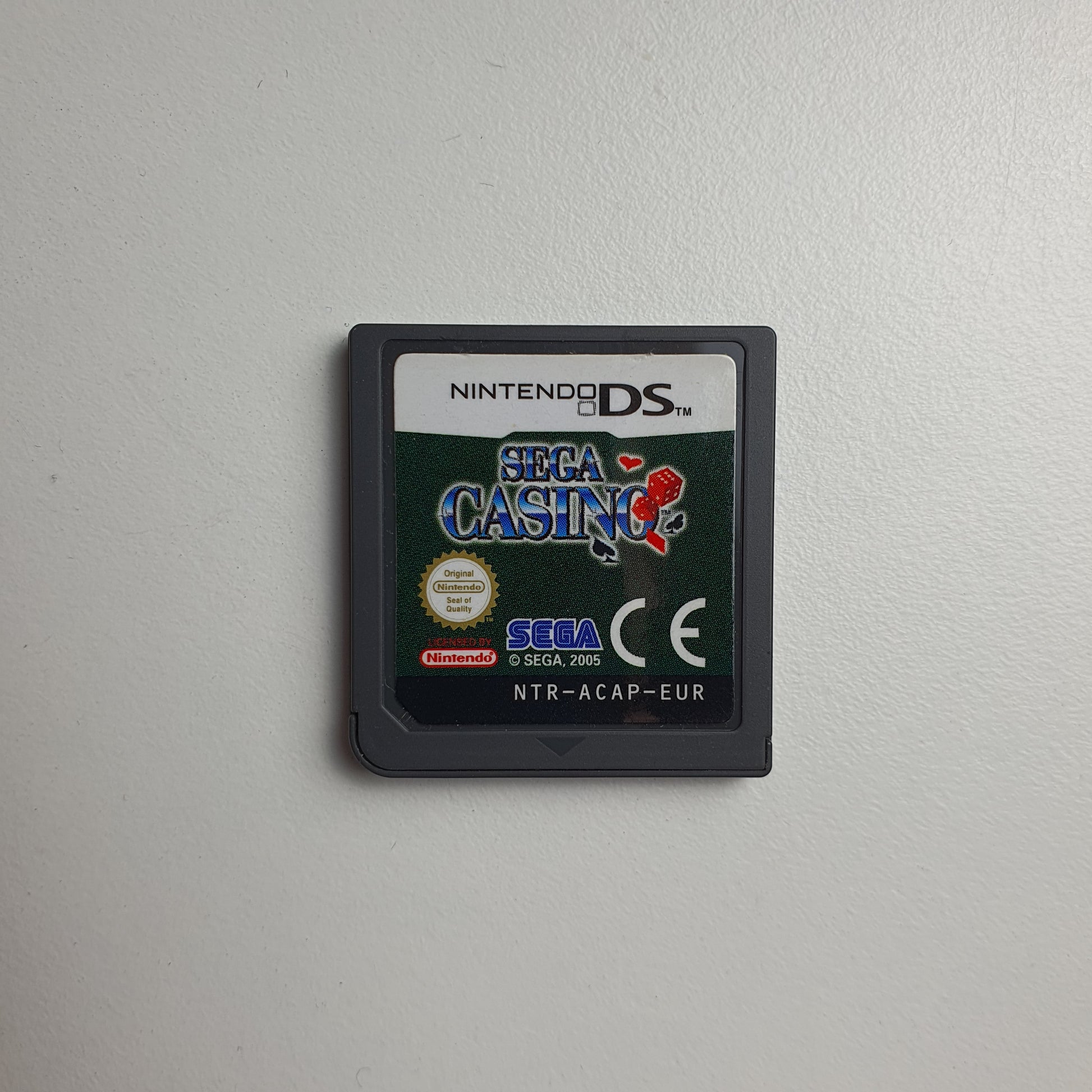 Nintendo DS game cartridge for Sega Casino on a light grey background