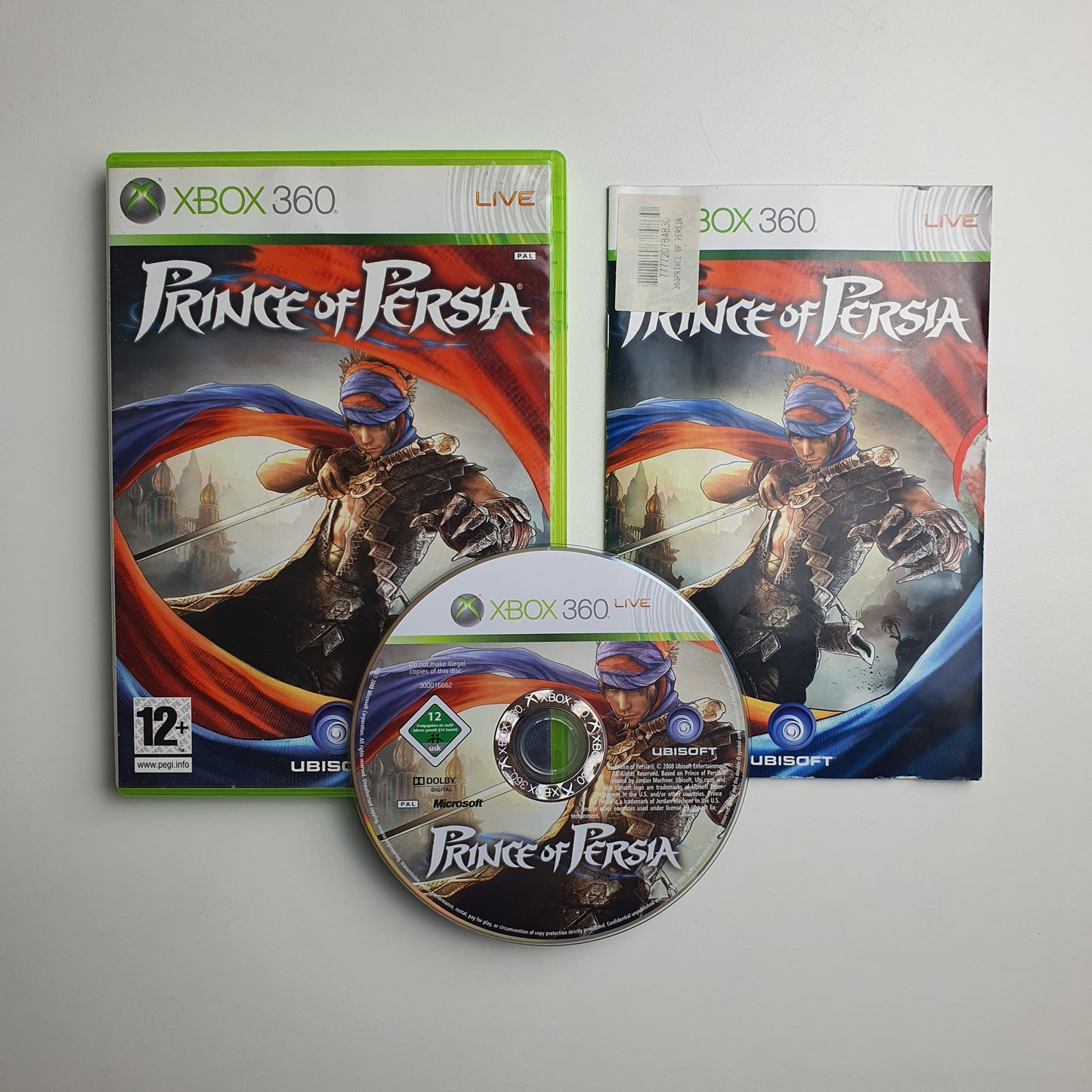 Prince of Persia game case, manual and disc on a grey background