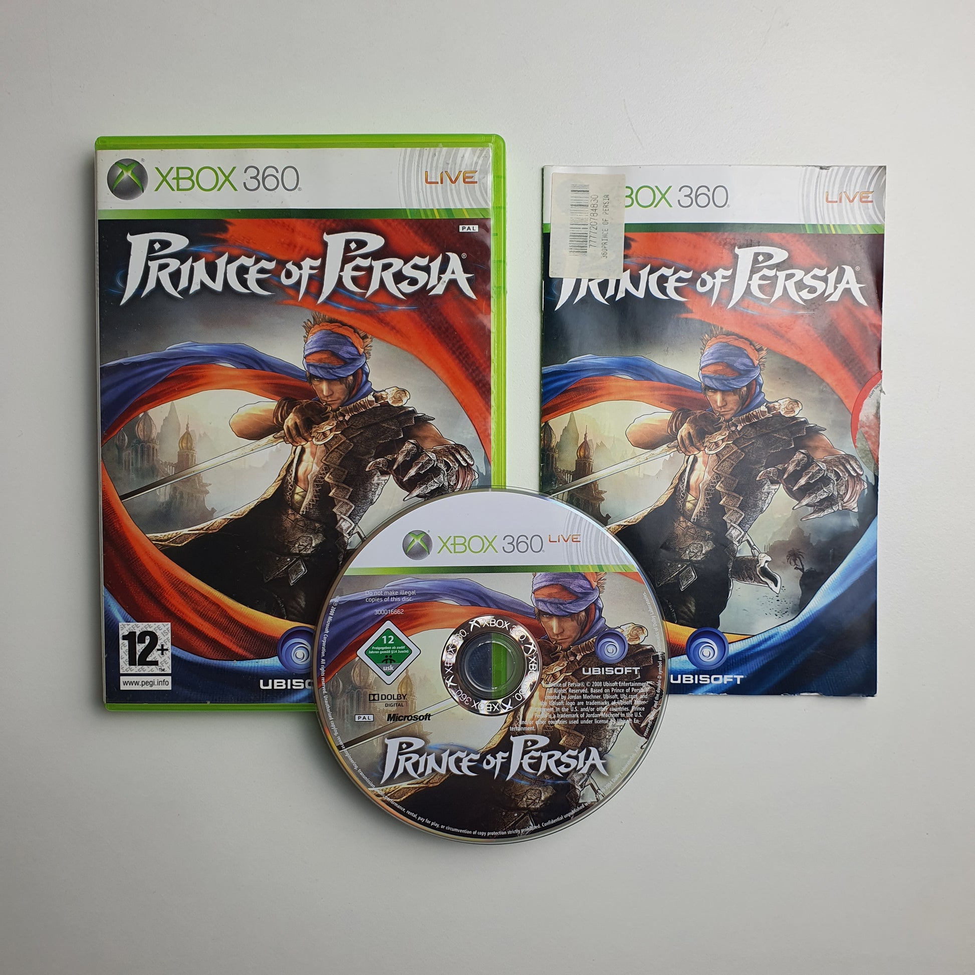 Prince of Persia game case, manual and disc on a grey background