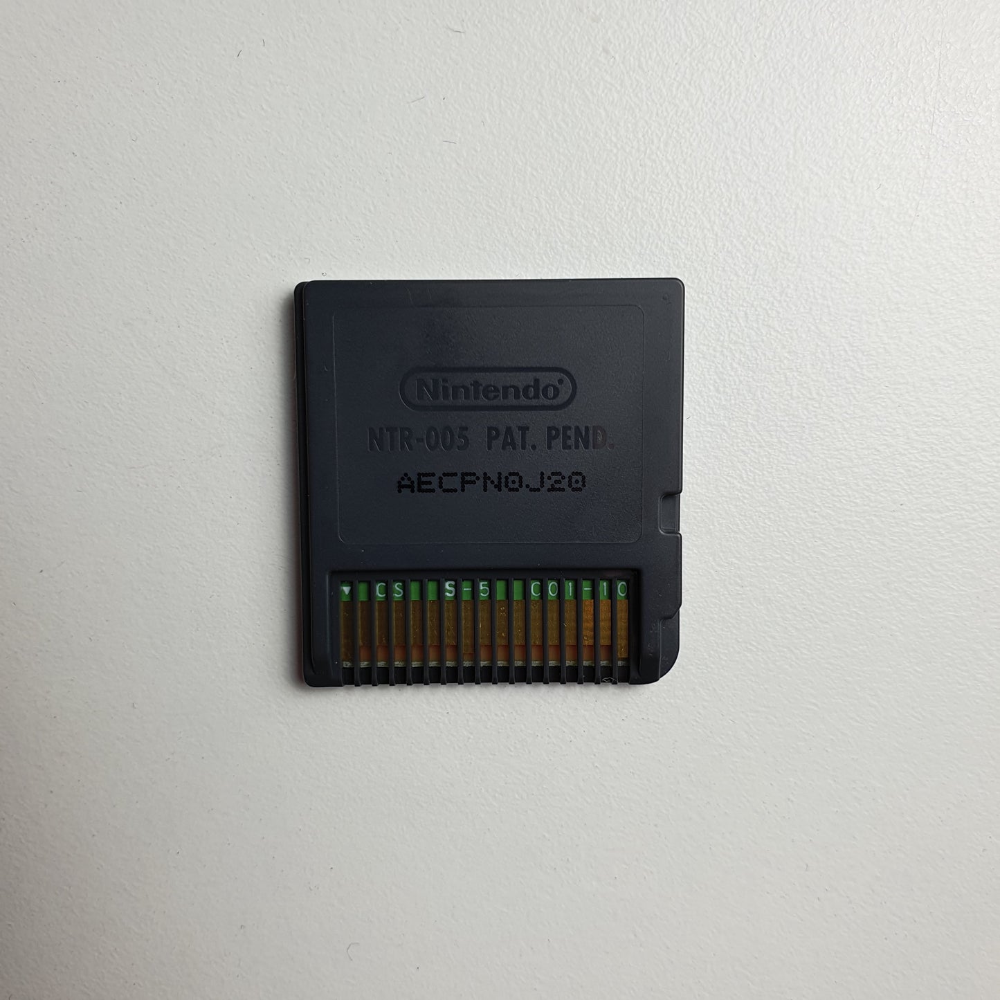 Back of a Nintendo DS game cartridge on a light grey background