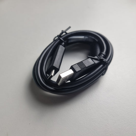 Black USB-A to USB-C changing cable on a light gray background