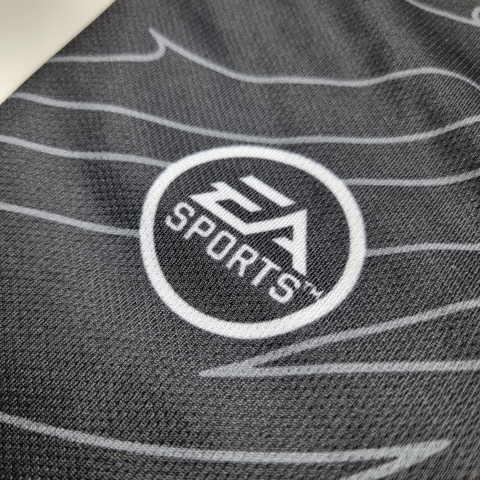 Close-up of a the EA Sports logo on a textured fabric surface
