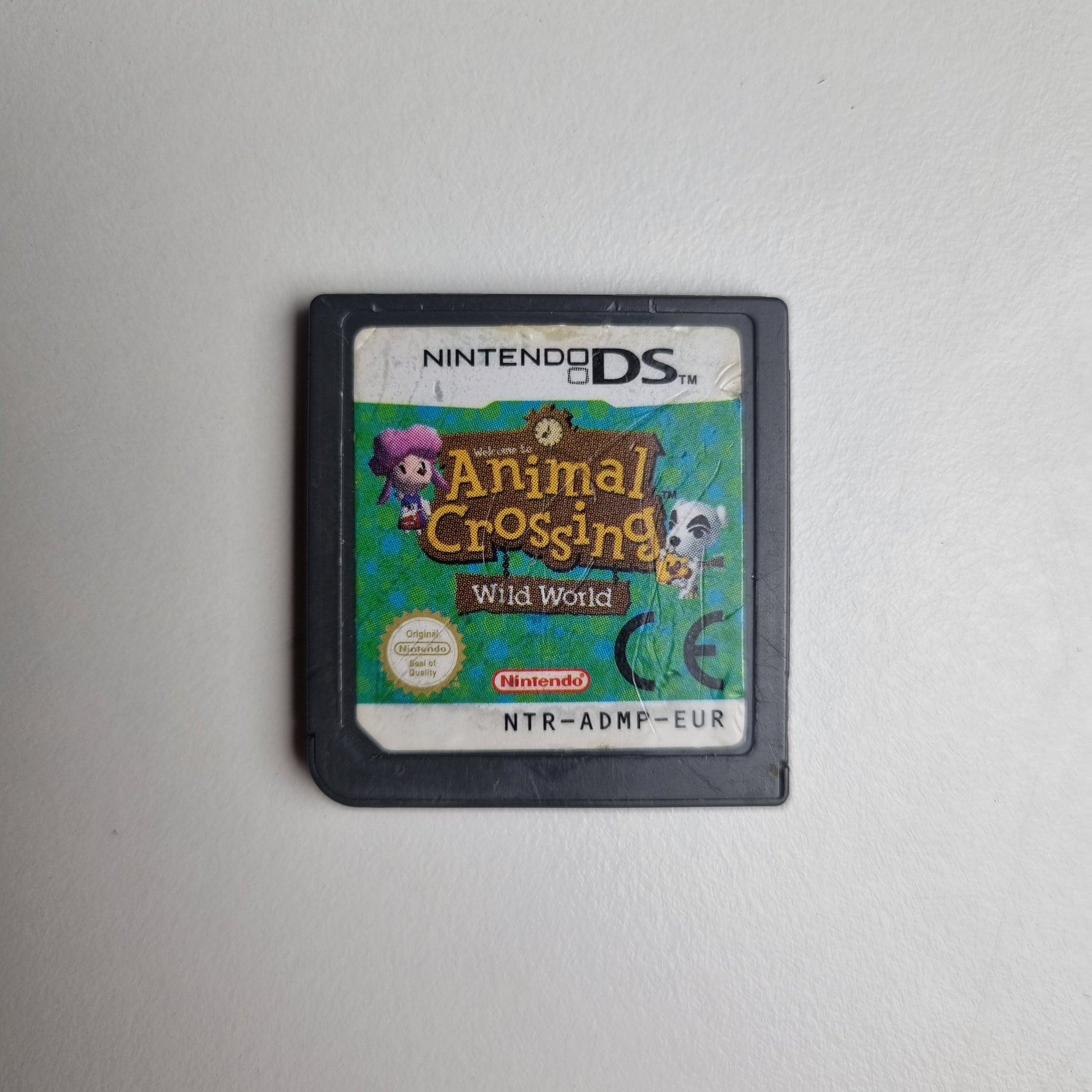 Animal Crossing: Wild World video game for the Nintendo DS, showing marks on the front label. The cartridge is on a white background.