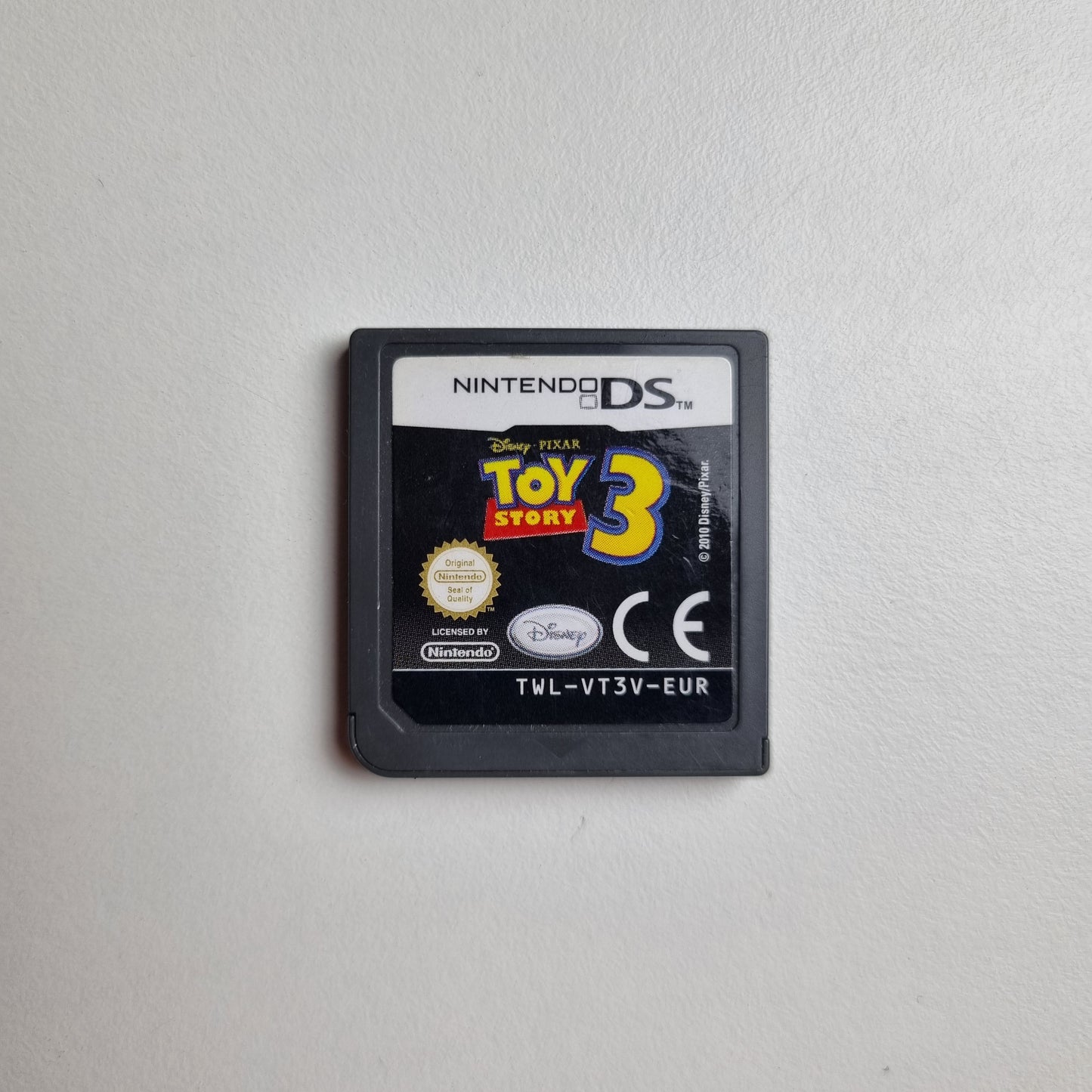 Nintendo DS game cartridge for 'Toy Story 3' on a light grey background
