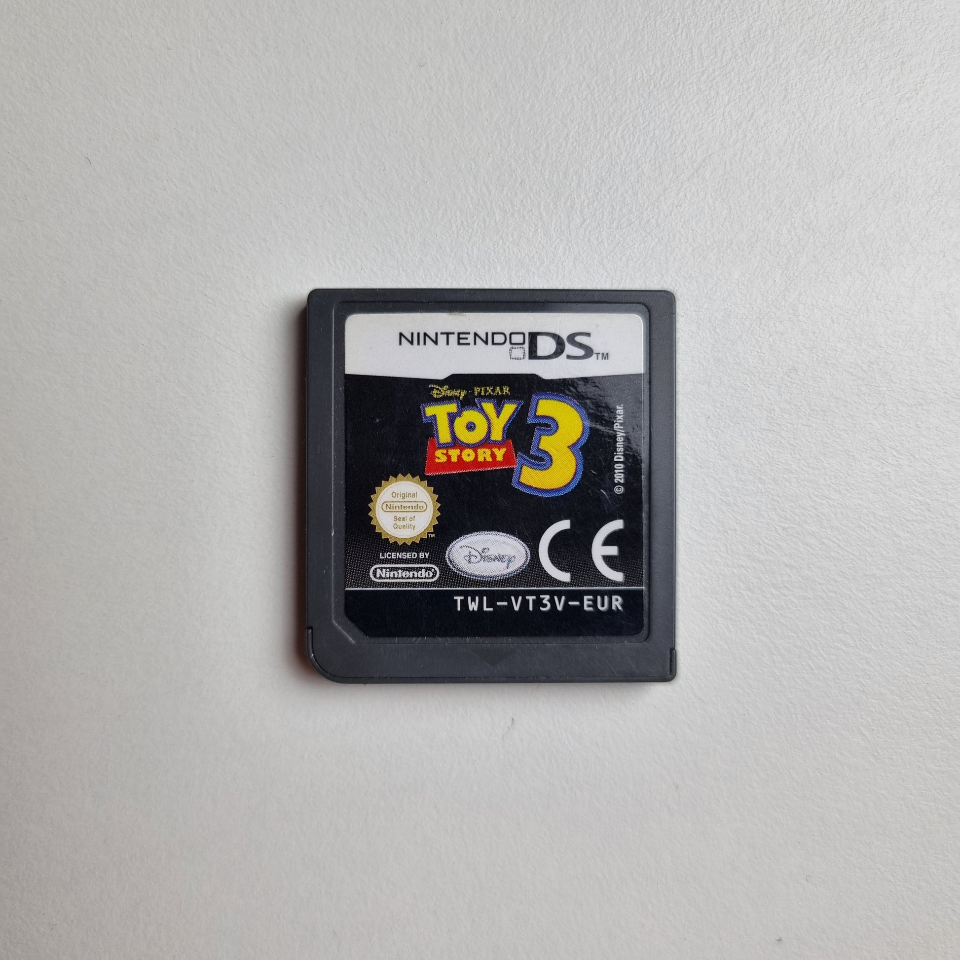Nintendo DS game cartridge for 'Toy Story 3' on a light grey background
