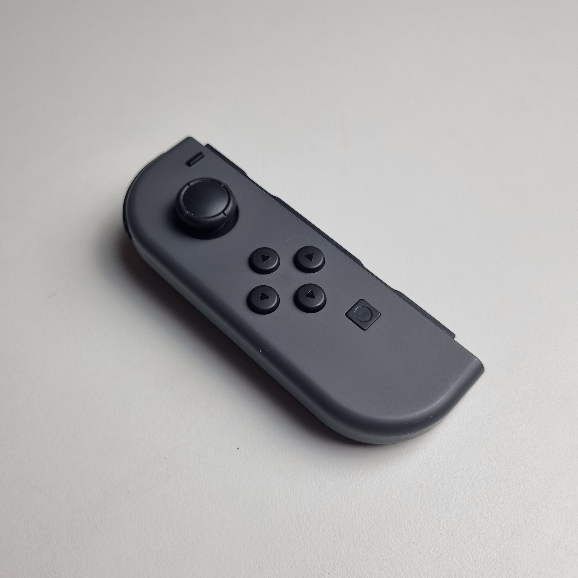 Grey Nintendo Switch Joy-Con on a white background.