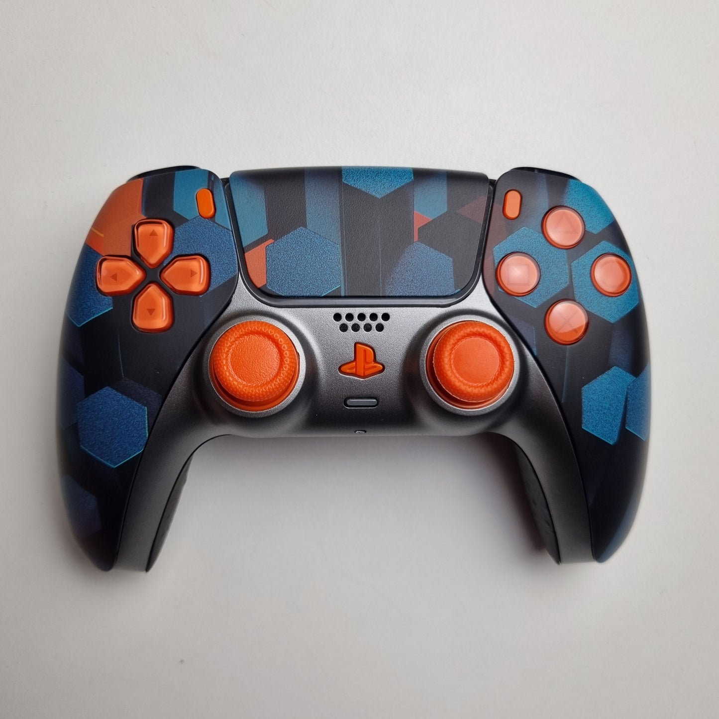 Custom orange, teal & black Sony PlayStation 5 PS5 wireless DualSense controller built by Dogghead Tech on a white background.